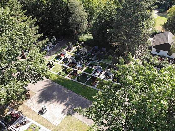 Luftbildaufnahme Friedhof Burk Luftbildaufnahme eines Friedhofs mit bunt bepflanzten Gräbern, umrahmt von großen Bäumen